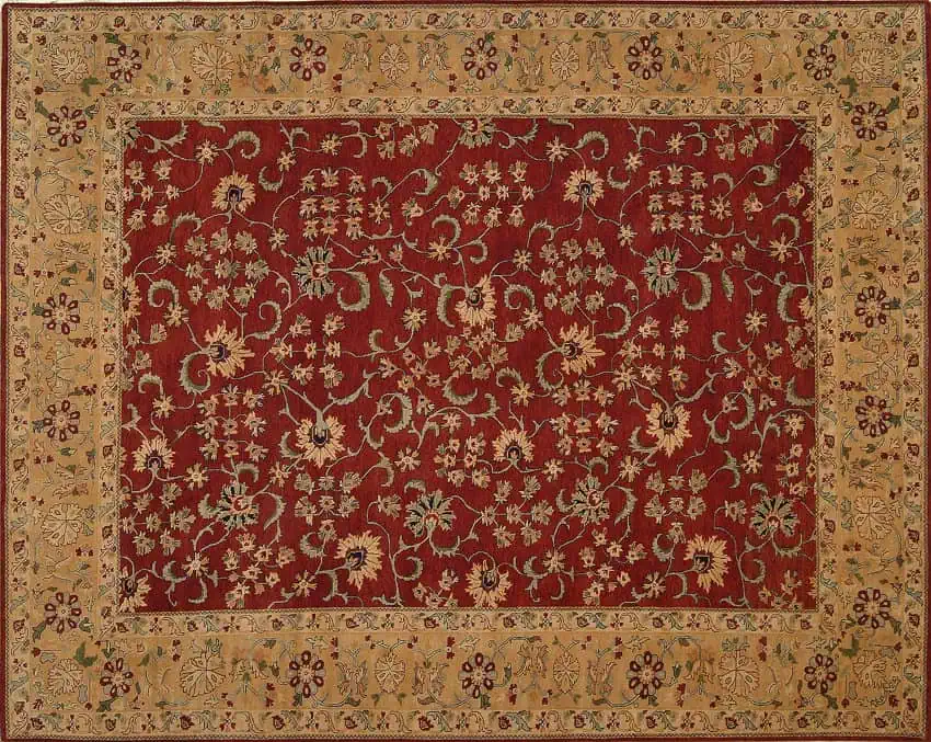 Handgeknoopt Agra tapijt uit India met een levendige rode achtergrond en ingewikkelde traditionele motieven.